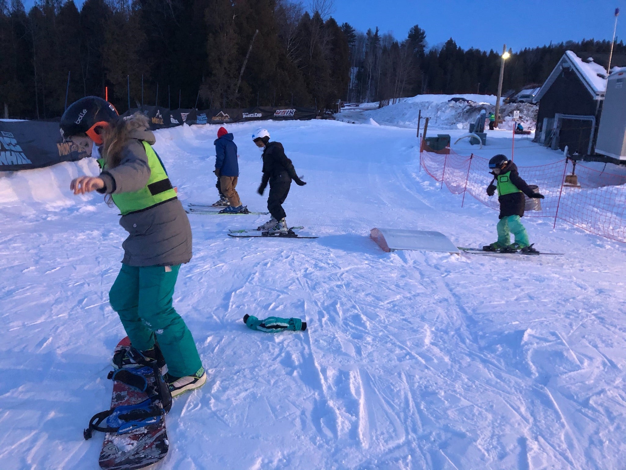 kids snowboarding in the snow